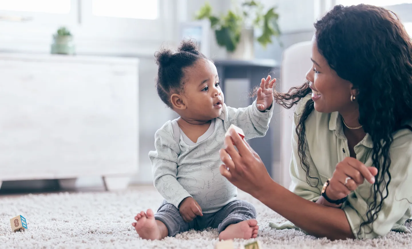 mom plays with infant