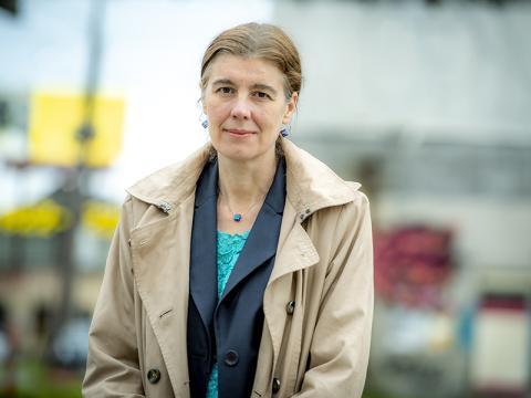 A headshot of Dr Emily Harville outside wearing a coat smiling at the camera